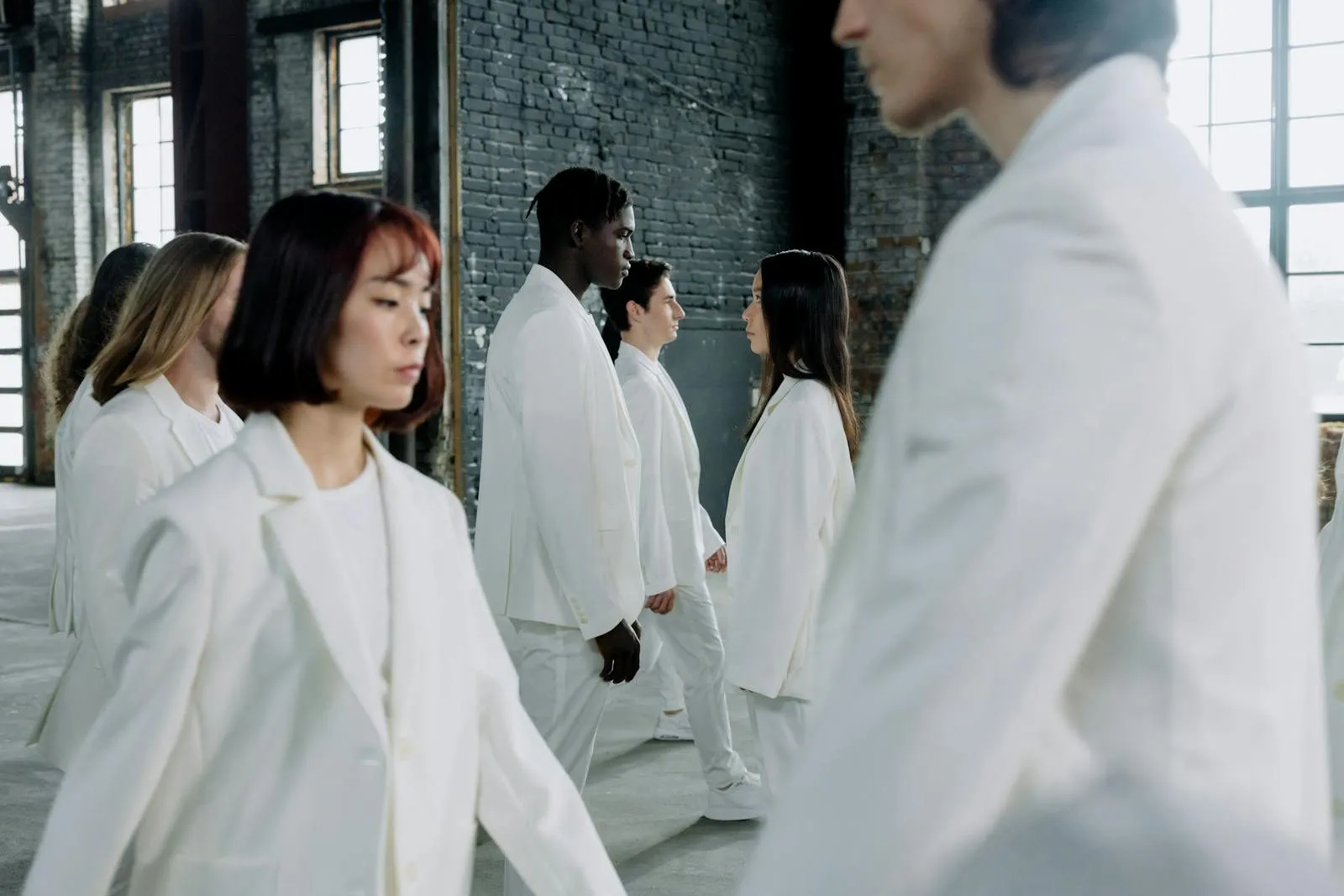 EU digital product passport regulation, diverse models in white suits walking indoors with natural light